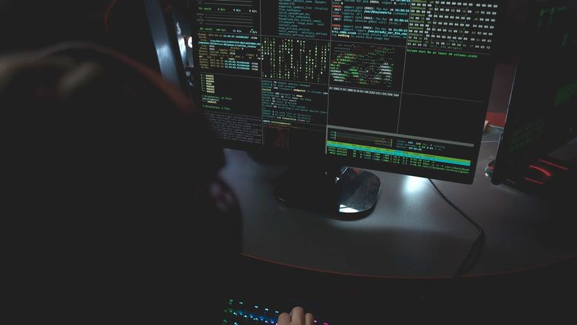 Karanlık bir çalışma ortamında açık terminal ve izleme ekranları